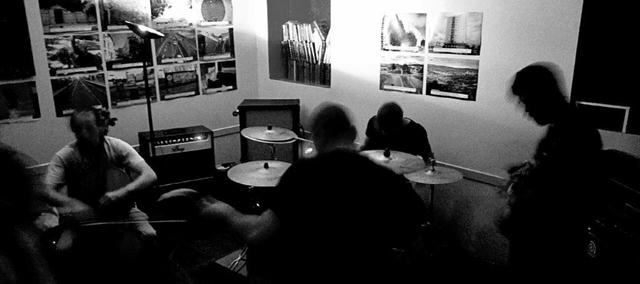 a b&w picture of a the band playing in a library